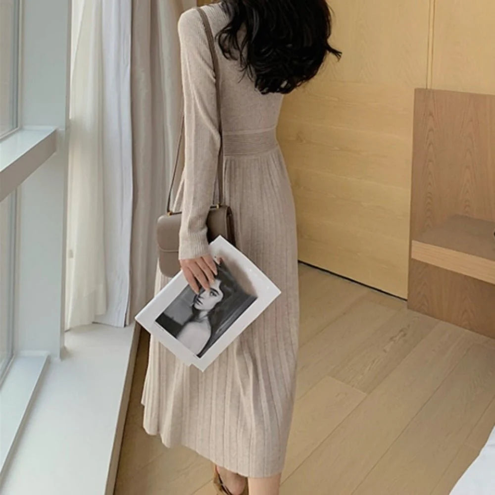 Pleated women's dress with fitted bodice and flowing skirt